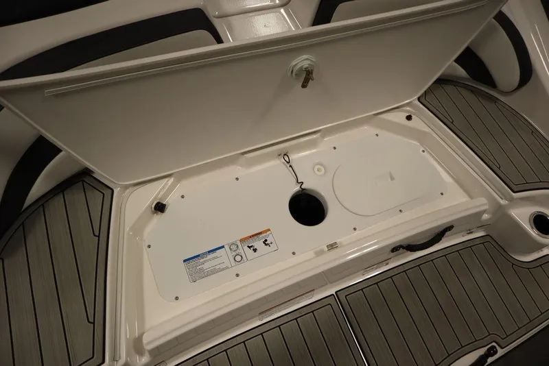 Slide: The Image of 2025 Yamaha Boats SX195 storage compartment with open hatch, showcasing interior design and features. - 35