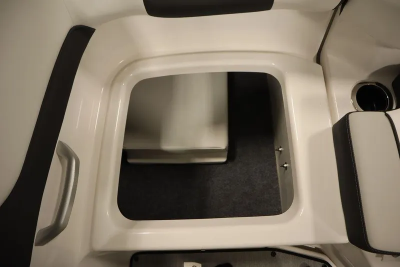 Slide: The Image of 2025 Yamaha Boats SX195 interior storage compartment with cup holder and handle. - 36