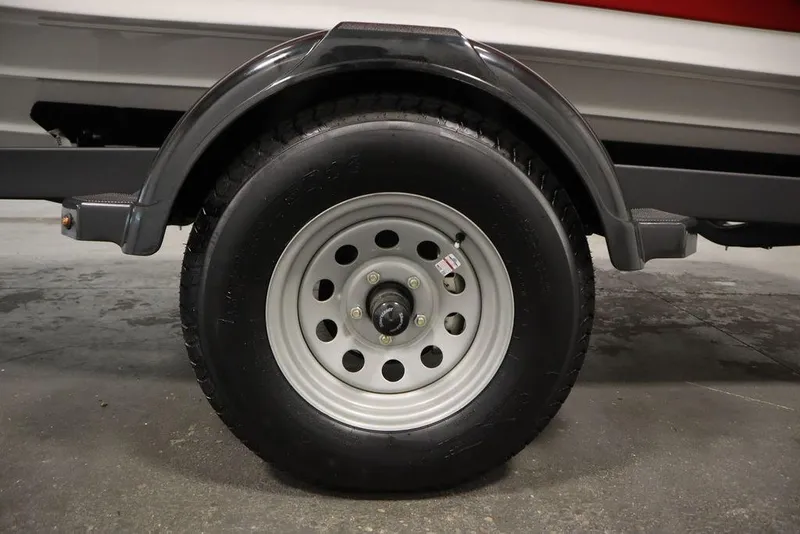 Slide: The Image of Trailer wheel of 2025 Yamaha Boats SX195, featuring a sturdy tire and metal rim. - 37