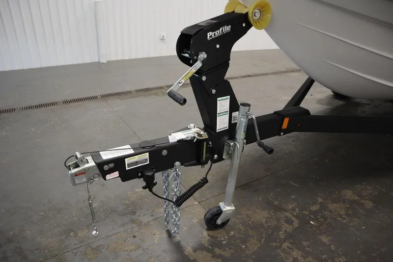 Slide: The Image of Trailer hitch of 2025 Yamaha Boats SX195, featuring a Profile winch and safety chains. - 38