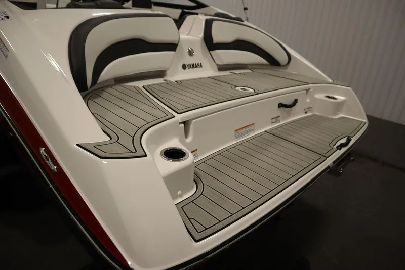 Slide: The Image of 2025 Yamaha Boats SX195 swim platform with sleek seating and cup holders. - 41