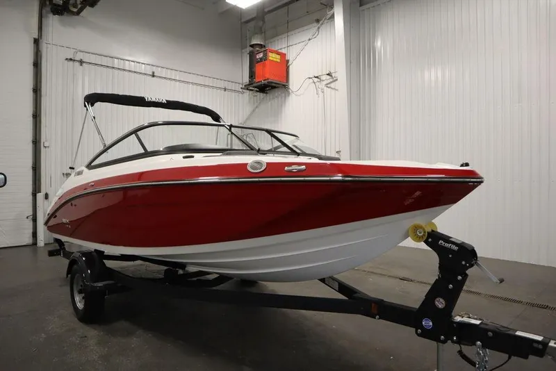 Slide: The Image of 2025 Yamaha Boats SX195 in a showroom, featuring a sleek red and white design. - 48