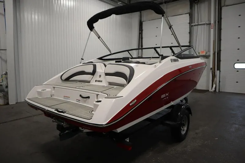 Slide: The Image of 2025 Yamaha Boats SX195 in a showroom, showcasing sleek design and modern features. - 49