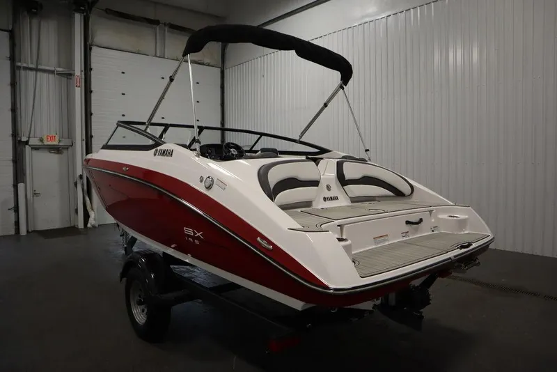 Slide: The Image of 2025 Yamaha Boats SX195 in a garage, showcasing sleek red and white design. - 50