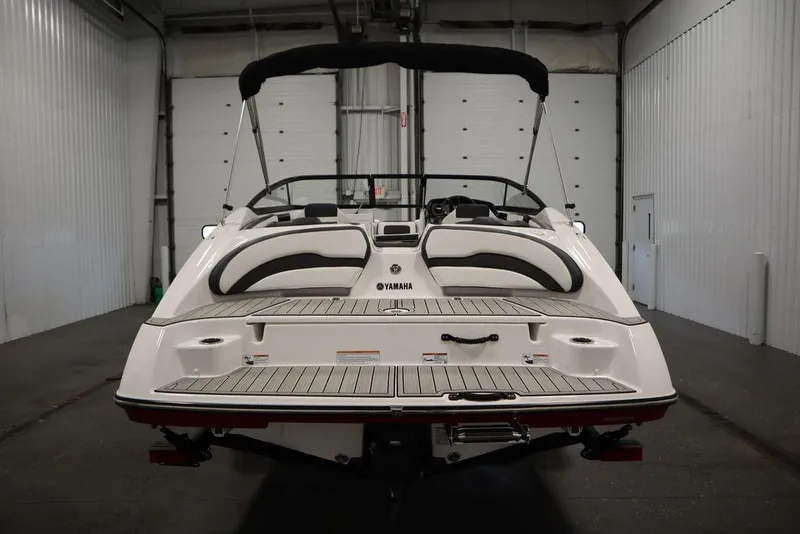 Slide: The Image of 2025 Yamaha Boats SX195 in a garage, rear view showcasing sleek design. - 52
