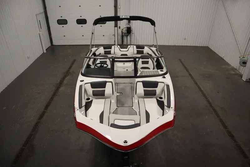 Slide: The Image of 2025 Yamaha Boats SX195 in a showroom, showcasing sleek design and spacious seating. - 53