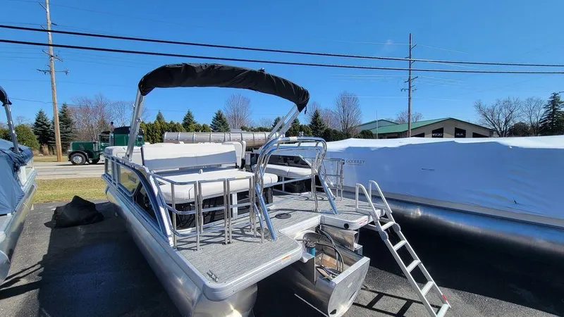 Slide: The Image of 2024 Godfrey Sweetwater 2286 SFL pontoon boat with center tube package, docked outdoors. - 10