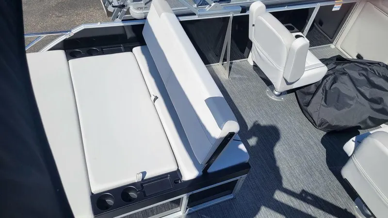 Slide: The Image of 2024 Godfrey Sweetwater 2286 SFL boat interior with seating and cup holders. - 11