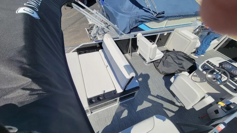 Slide: The Image of 2024 Godfrey Sweetwater 2286 SFL GTP pontoon boat interior with seating and steering console. - 12