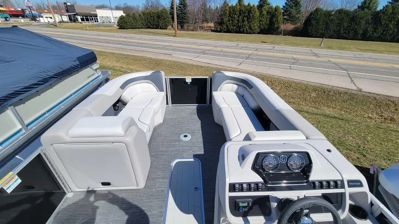 Slide: The Image of 2024 Godfrey Sweetwater 2286 SFL boat interior with modern seating and dashboard. - 3