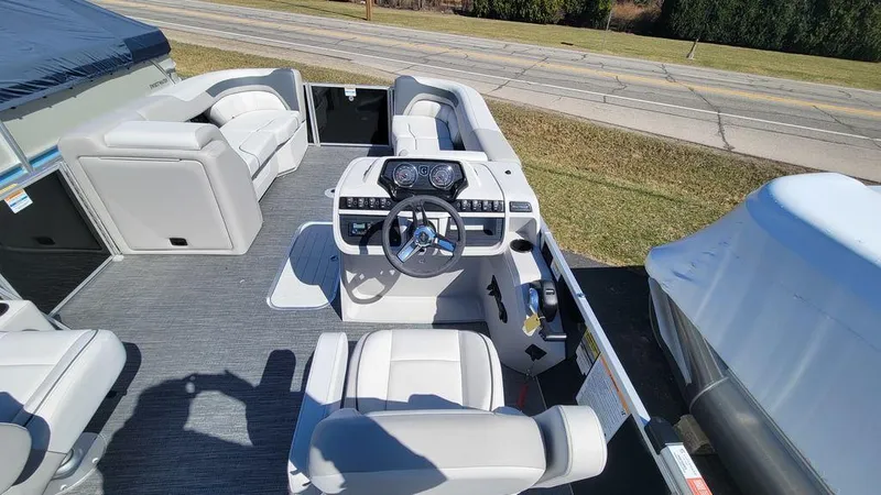 Slide: The Image of 2024 Godfrey Sweetwater 2286 SFL GTP boat interior with steering console and seating. - 4