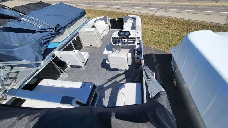 Slide: The Image of 2024 Godfrey Sweetwater 2286 SFL GTP pontoon boat interior with seating and helm. - 6