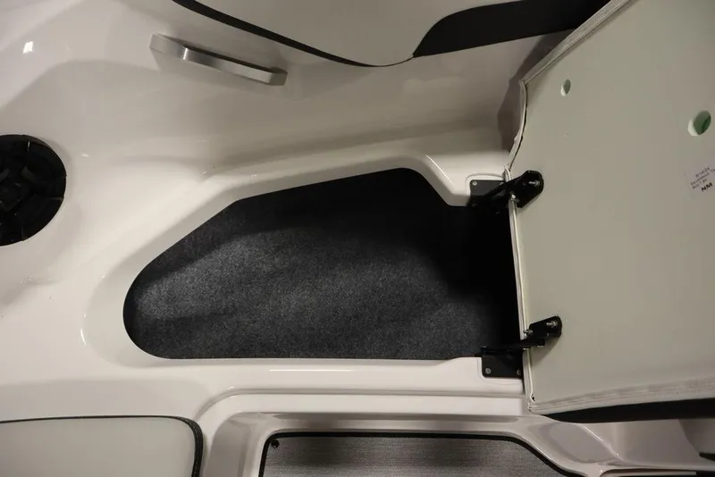 Slide: The Image of 2025 Yamaha Boats 195 SX interior storage compartment with open hatch. - 16