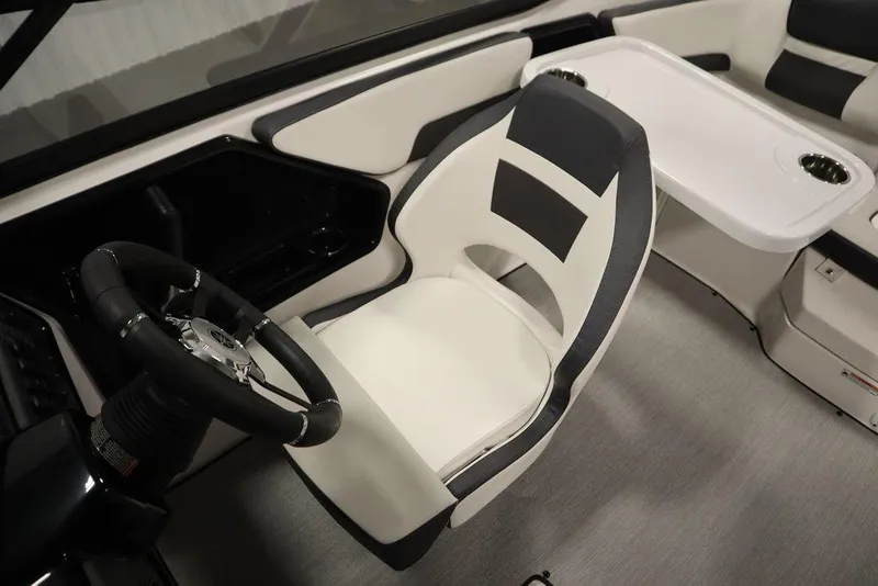 Slide: The Image of Interior of 2025 Yamaha Boats 195 SX, featuring sleek seating and modern steering wheel design. - 31