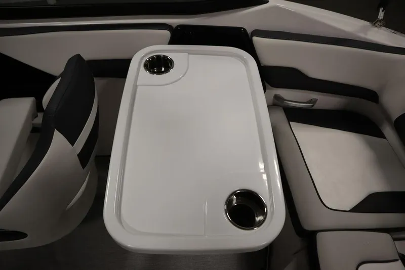 Slide: The Image of Interior of 2025 Yamaha Boats 195 SX, featuring a sleek table with cup holders. - 44