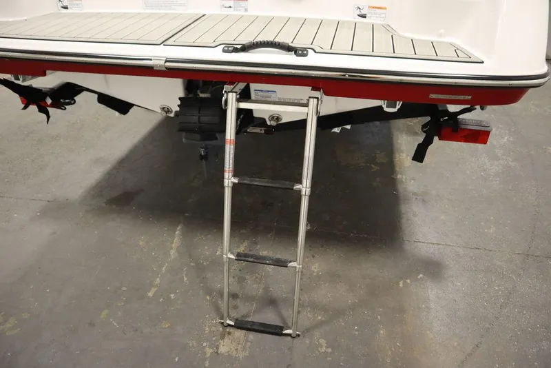 Slide: The Image of 2025 Yamaha Boats 195 SX with extended swim ladder on the rear deck. - 48