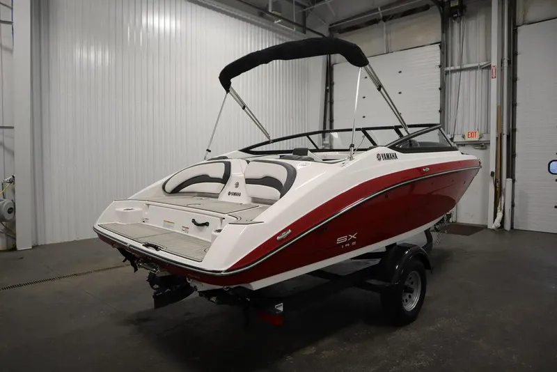 Slide: The Image of 2025 Yamaha Boats 195 SX in a garage, featuring sleek red and white design. - 5