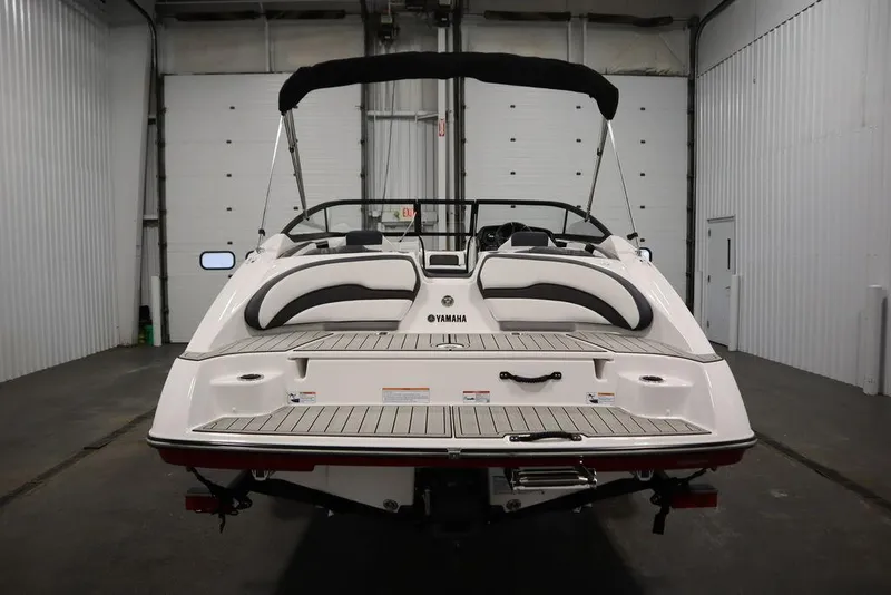Slide: The Image of 2025 Yamaha Boats 195 SX in a garage, rear view with sleek design. - 6