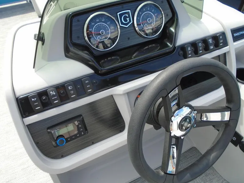 Slide: The Image of 2025 Godfrey Sweetwater 2286 C dashboard with steering wheel and control panel. - 11