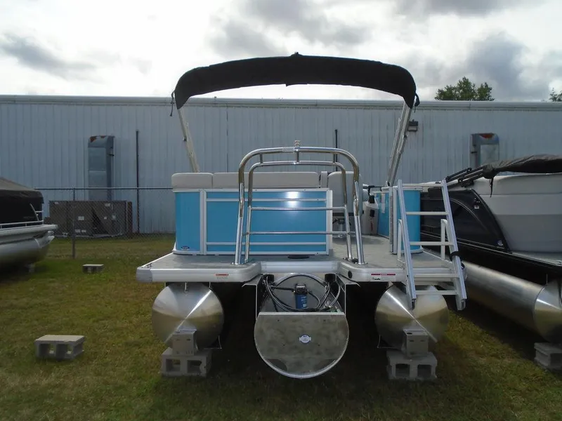 Slide: The Image of 2025 Godfrey Sweetwater 2286 C pontoon boat with canopy, parked on grass. - 15