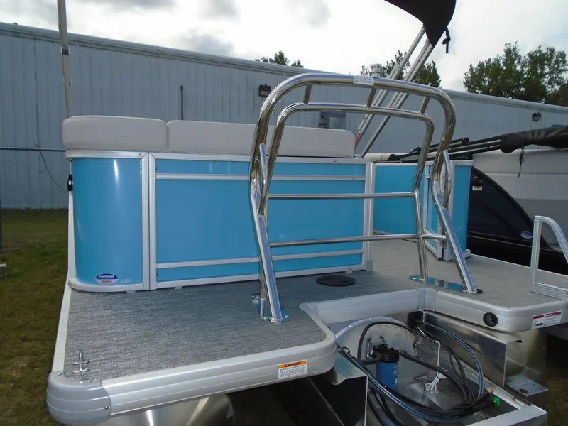 Slide: The Image of 2025 Godfrey Sweetwater 2286 C pontoon boat, blue paneling, rear view with ladder. - 18