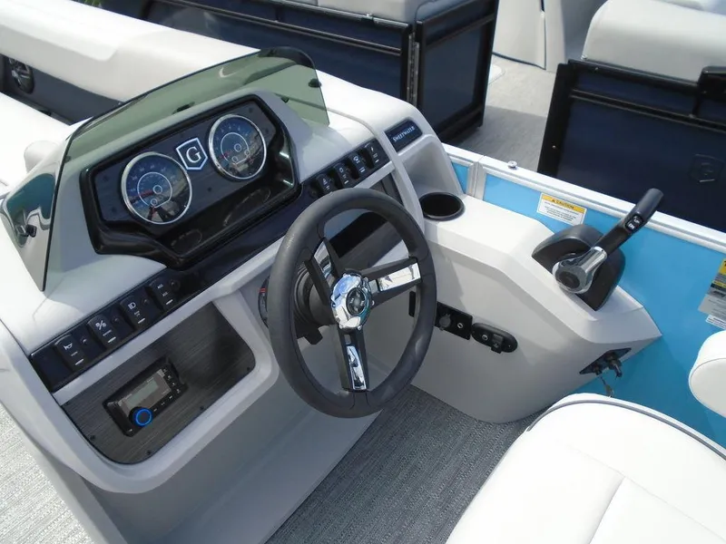 Slide: The Image of 2025 Godfrey Sweetwater 2286 C boat dashboard with steering wheel and control panel. - 4