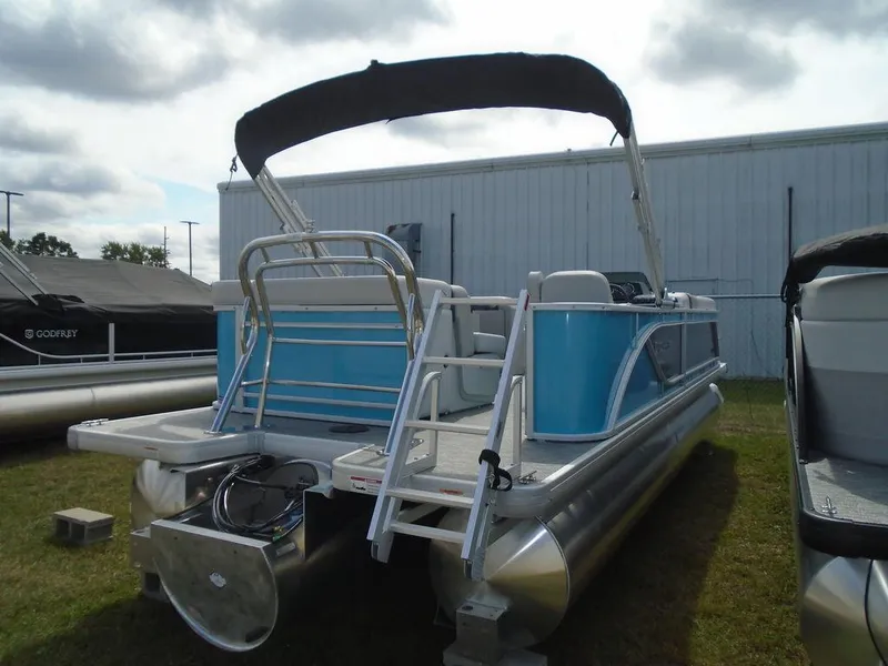 Slide: The Image of 2025 Godfrey Sweetwater 2286 C pontoon boat with blue accents and canopy. - 5