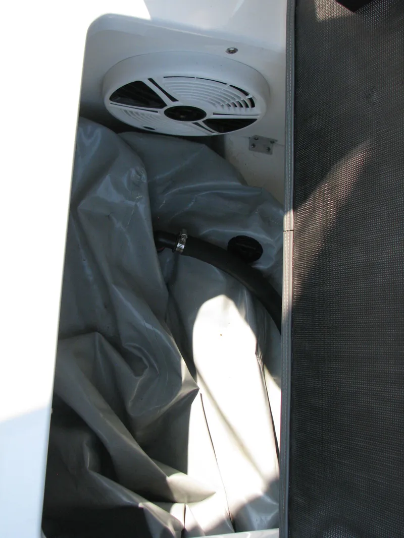 Slide: The Image of 2015 Chaparral Vortex 223 VRX-Surf boat interior with speaker and storage area. - 10