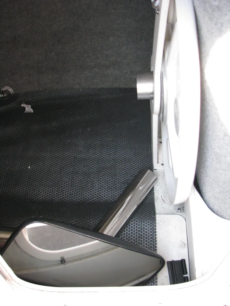 Slide: The Image of Interior of 2015 Chaparral Vortex 223 VRX-Surf boat, featuring storage compartment. - 13