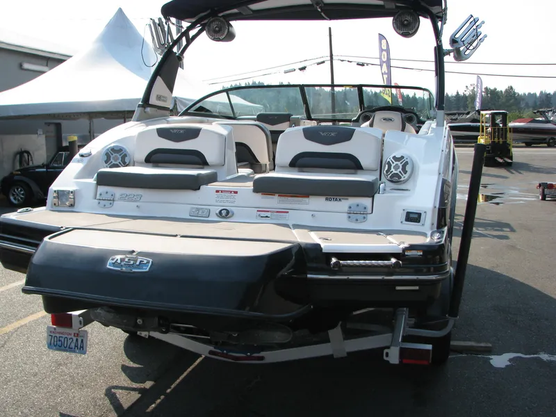 Slide: The Image of 2015 Chaparral Vortex 223 VRX-Surf boat, rear view, parked outdoors. - 2