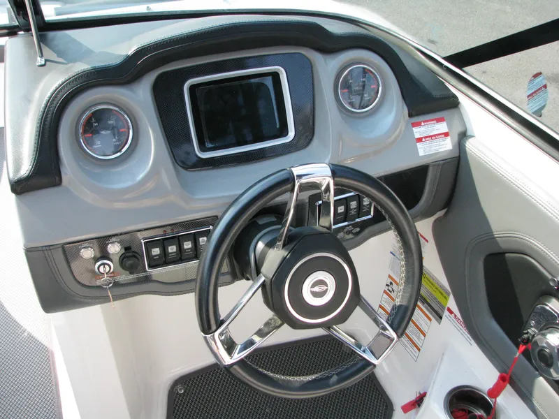 Slide: The Image of 2015 Chaparral Vortex 223 VRX-Surf boat dashboard with steering wheel and controls. - 6