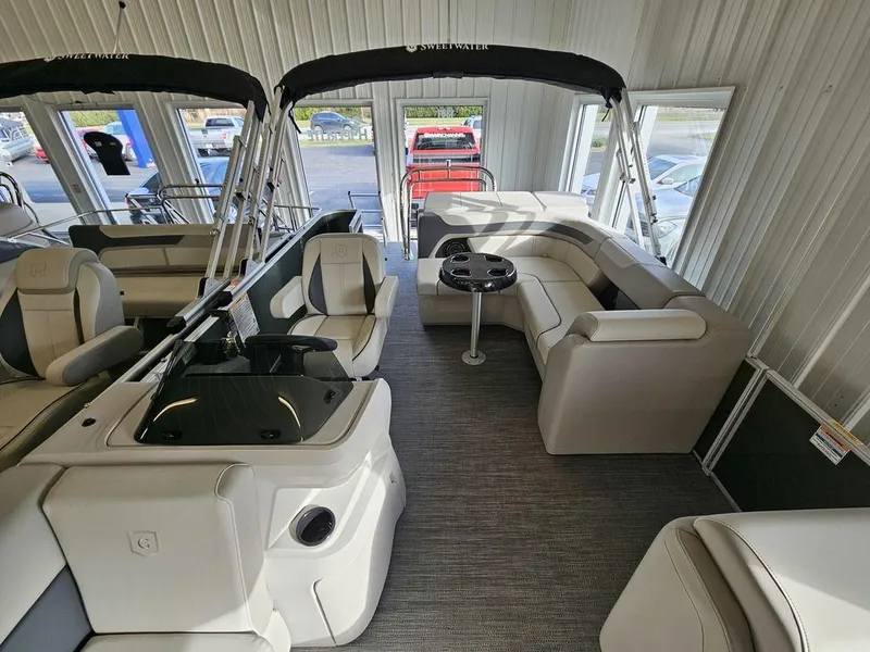 Slide: The Image of 2025 Godfrey Sweetwater 2286 C pontoon boat interior with seating and helm. - 13