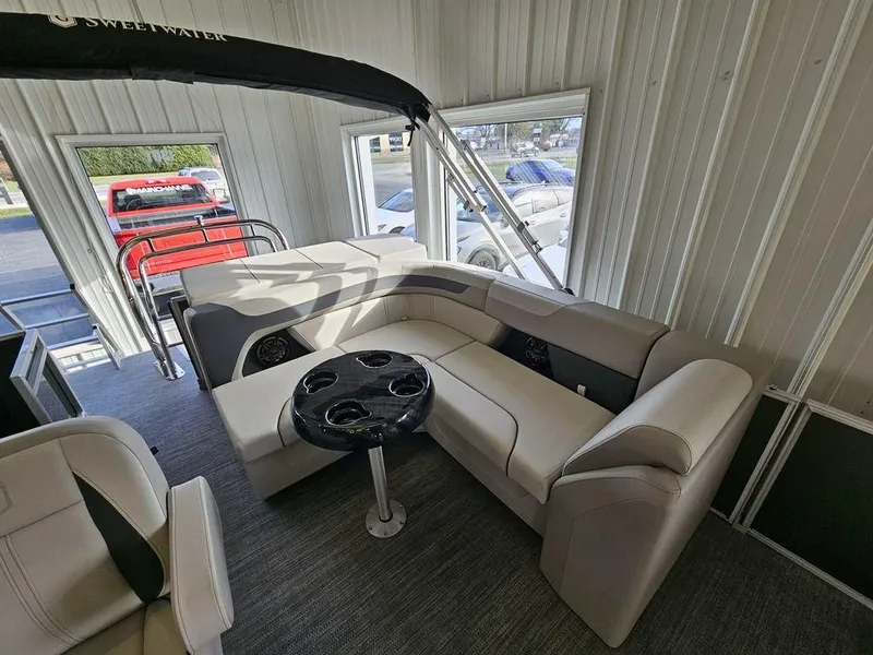Slide: The Image of 2025 Godfrey Sweetwater 2286 C pontoon boat interior with plush seating and cup holders. - 14