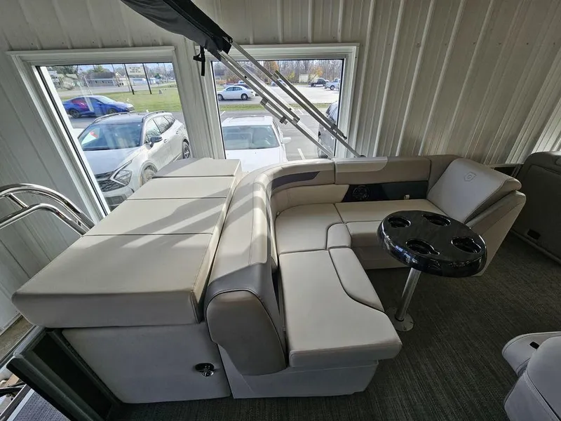 Slide: The Image of 2025 Godfrey Sweetwater 2286 C pontoon boat interior with plush seating and cup holders. - 16