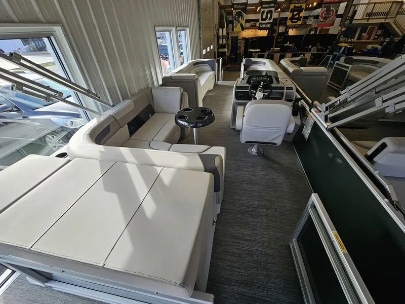 Slide: The Image of 2025 Godfrey Sweetwater 2286 C pontoon boat interior with plush seating and modern helm. - 17
