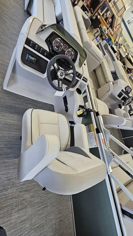 Slide: The Image of 2025 Godfrey Sweetwater 2286 C boat interior with modern steering console and seating. - 6