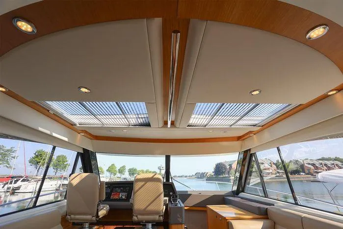 Slide: The Image of Interior view of 2016 Riviera 525 SUV yacht with panoramic windows and luxurious seating. - 27