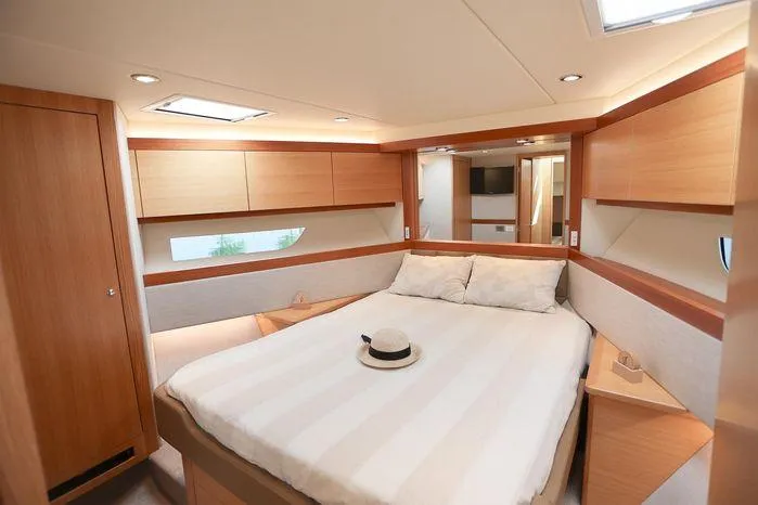 Slide: The Image of Luxurious bedroom interior of 2016 Riviera 525 SUV yacht with modern wood finishes. - 3