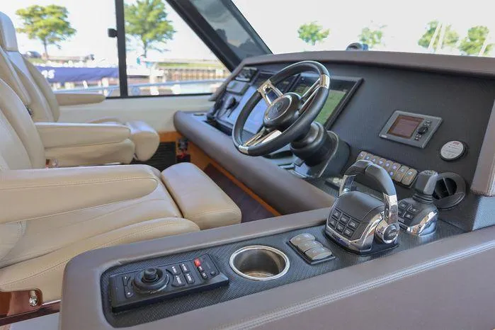 Slide: The Image of Interior of 2016 Riviera 525 SUV yacht cockpit with steering wheel and controls. - 32