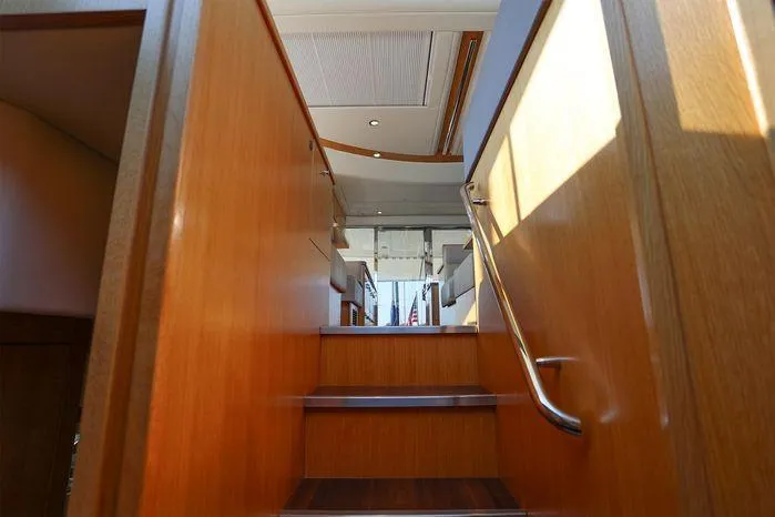 Slide: The Image of Interior stairs of 2016 Riviera 525 SUV yacht, featuring wooden finish and modern design. - 34