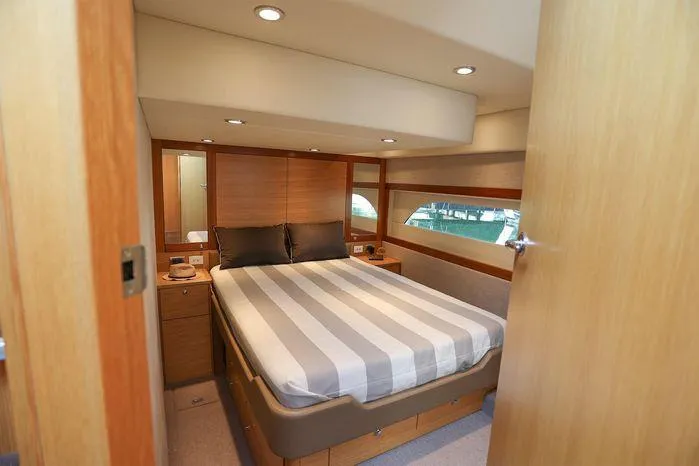 Slide: The Image of Luxurious bedroom interior of 2016 Riviera 525 SUV yacht with striped bedding. - 39