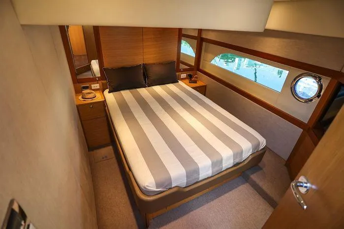 Slide: The Image of Luxurious bedroom interior of 2016 Riviera 525 SUV yacht with striped bedding. - 40