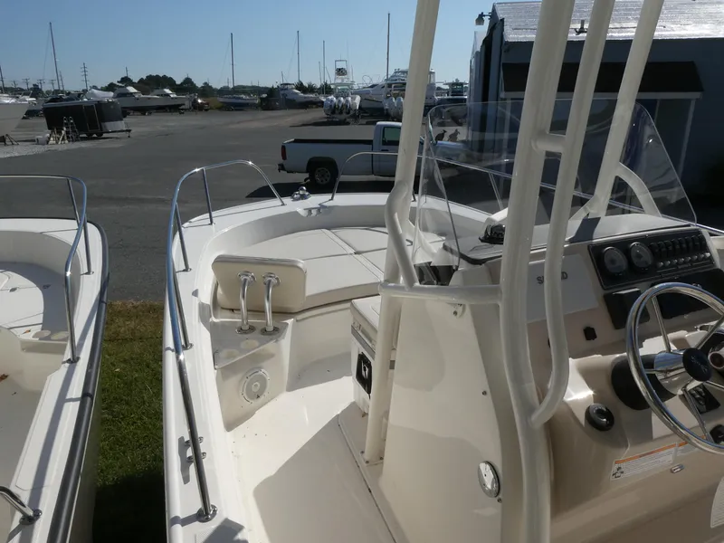 Slide: The Image of 2025 Boston Whaler 210 Montauk boat interior with steering console and seating. - 6