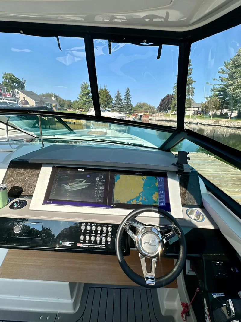 Slide: The Image of 2021 Sea Ray SLX 400 Outboard helm with advanced navigation system and steering wheel. - 10