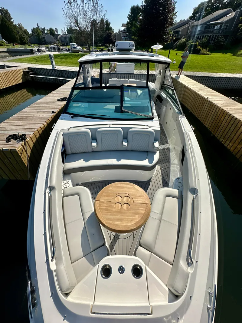 Slide: The Image of 2021 Sea Ray SLX 400 Outboard boat with spacious seating and wooden table. - 12