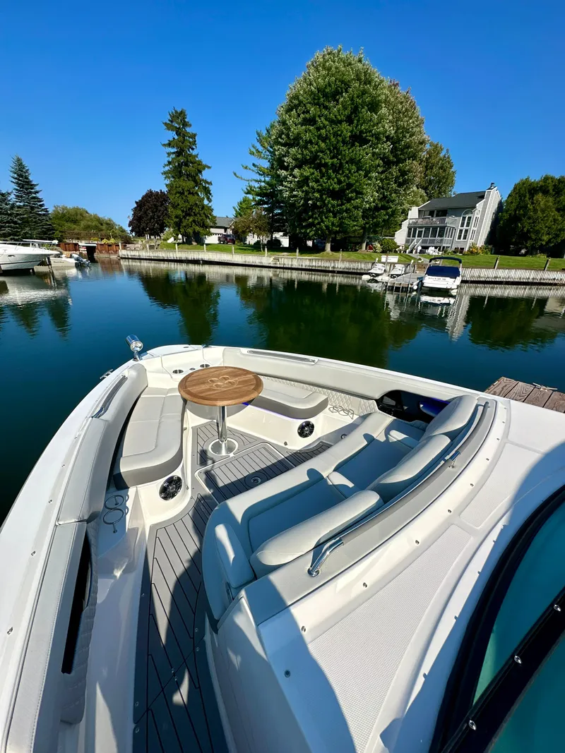 Slide: The Image of 2021 Sea Ray SLX 400 Outboard docked by a serene waterfront property. - 13