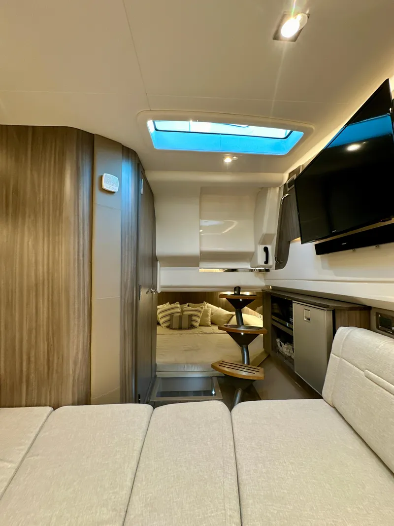 Slide: The Image of 2021 Sea Ray SLX 400 Outboard interior with modern design, skylight, and entertainment area. - 16