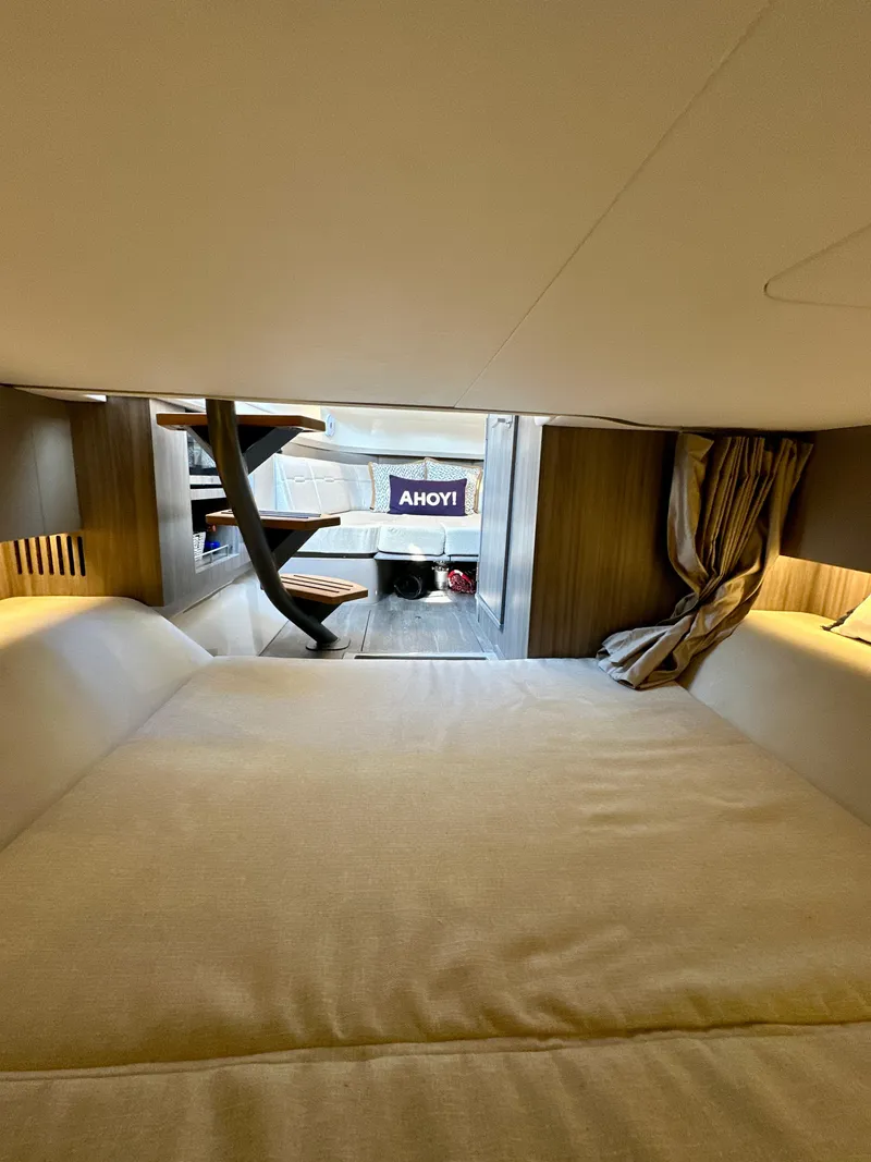 Slide: The Image of Interior cabin of 2021 Sea Ray SLX 400 Outboard with cozy bedding and modern design. - 17