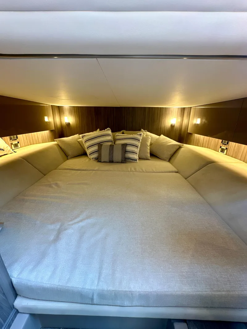 Slide: The Image of Luxurious cabin interior of 2021 Sea Ray SLX 400 Outboard with cozy bedding. - 19