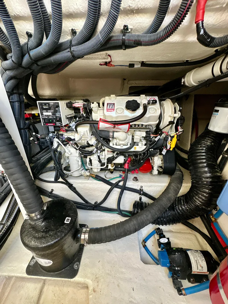 Slide: The Image of Engine compartment of 2021 Sea Ray SLX 400 Outboard with visible wiring and components. - 28